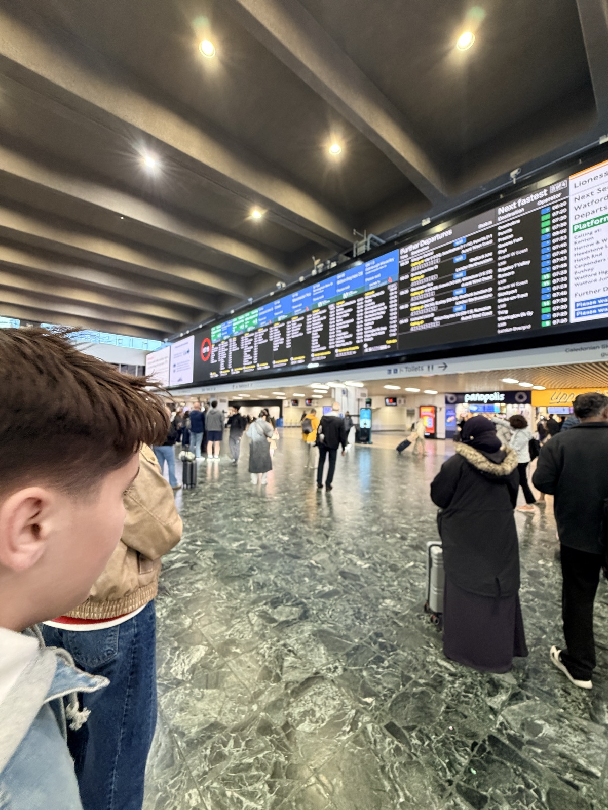 My son under the departures board at London Euston — the morning everything on that board went wrong.