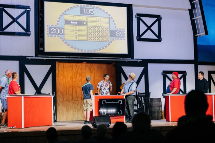 Guests on stage for the game show — family-feud style, barn backdrop and all.
